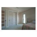 The custom whitewash finish of these birch TM5000 doors ties in with the pastel color scheme of the home.